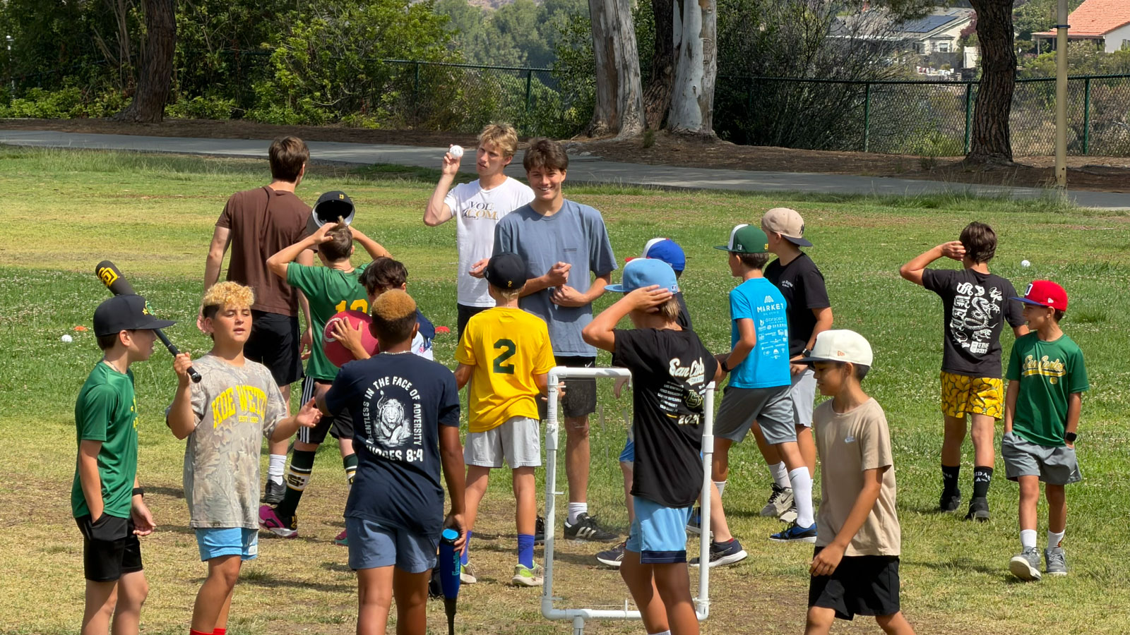 Roman and Jack leading a group of kids at a JR All Stars morning at Tuxedo Park